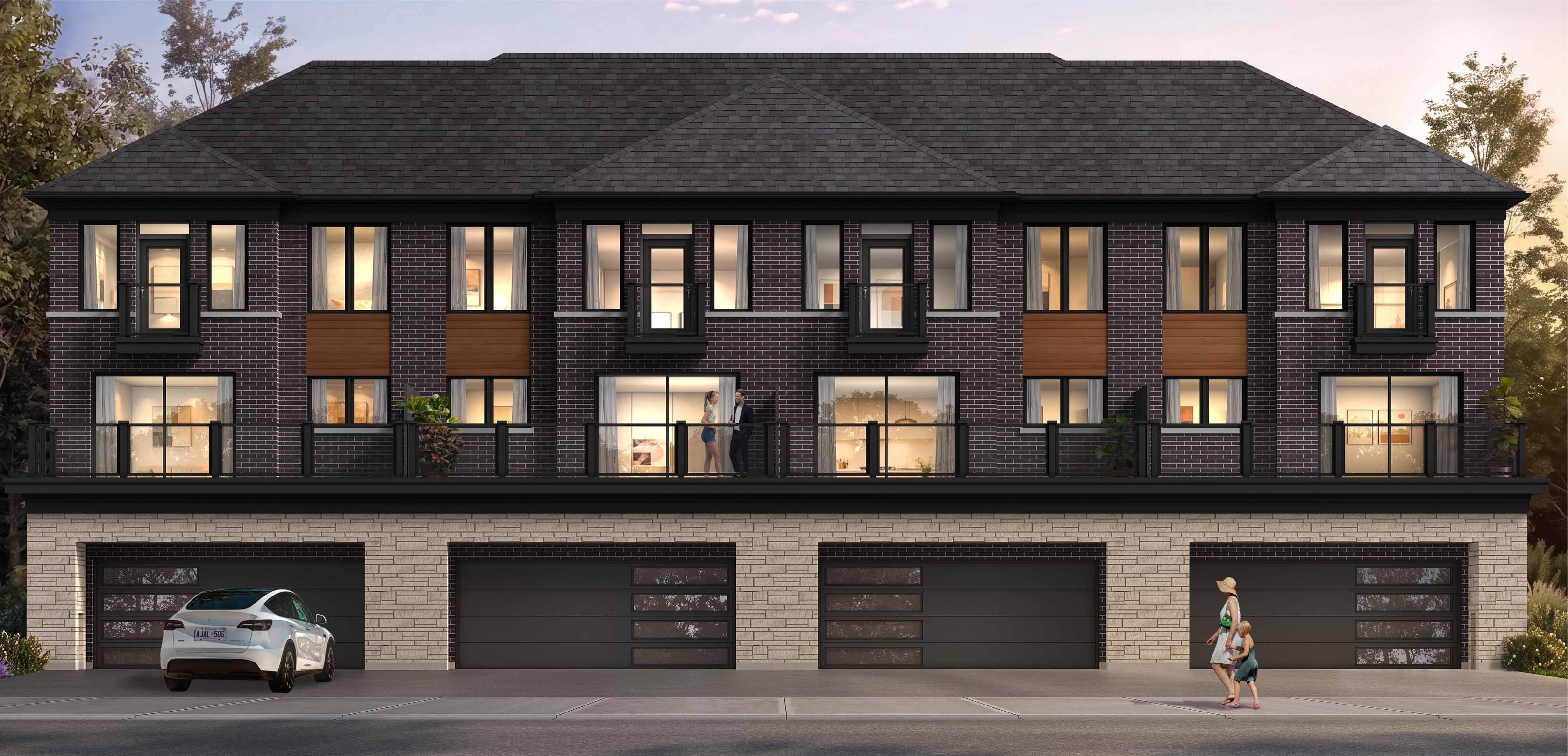 Street-facing rendering of Cornerstone Towns with garages, balconies, and warm interior lighting